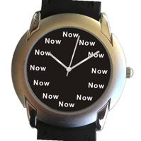 "Now" Is the Time That Is Shown Each Hour on the Black Dial of the 2-tone Polished and Brushed Chrome Round with a Black Leather Strap