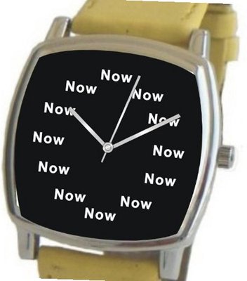 "Now" Is the Time That Is Shown Each Hour on the Black Dial of the Polished Chrome Cushion Shape with a Yellow Leather Strap