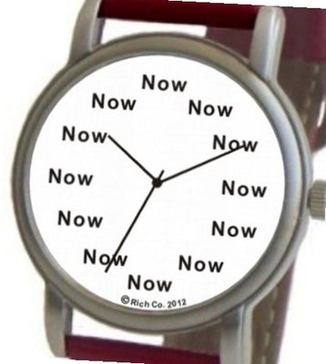 "Now" Is the Time That Is Shown Each Hour on the White Dial of the Brushed Chrome Round Shape with a Red Leather Strap